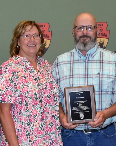 Cindy and Randy Malson accept the Oklahoma Department of Wildlife Conservation’s 2024 Landowner Conservationist of the Year Award at the August meeting of the Oklahoma Wildlife Conservation Commission.